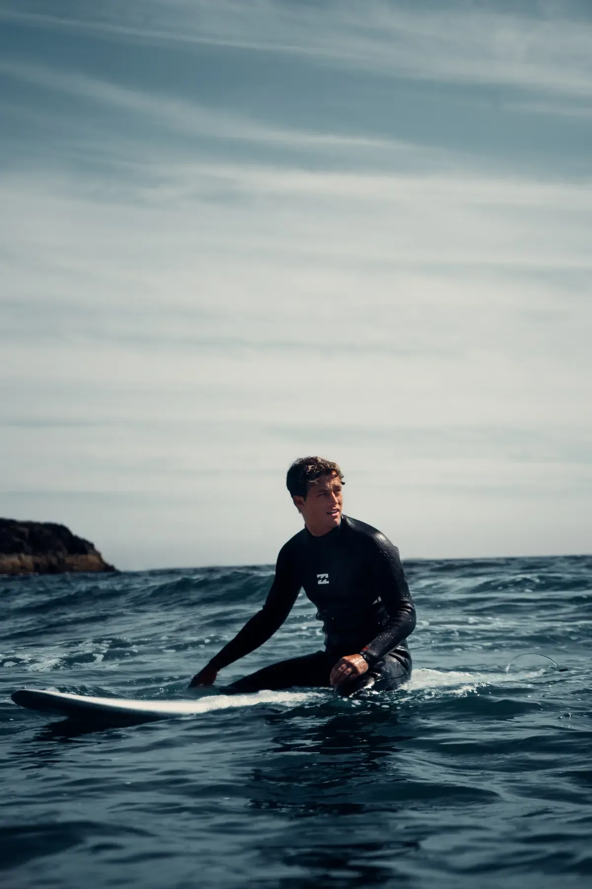 Surfer sitting beyond the break