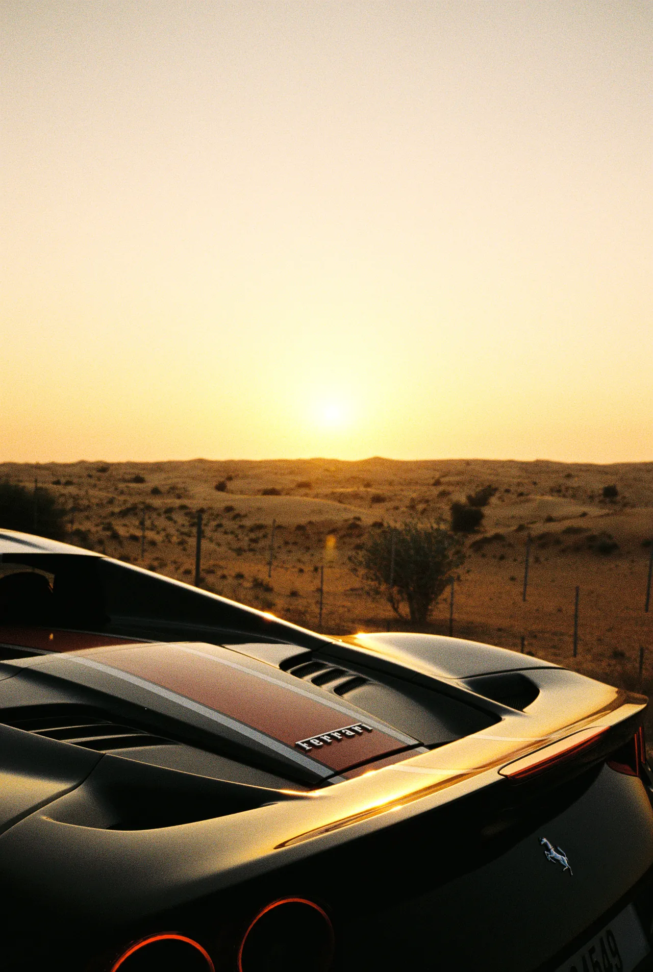 Sunset over the desert from the rear deck of a Ferrari